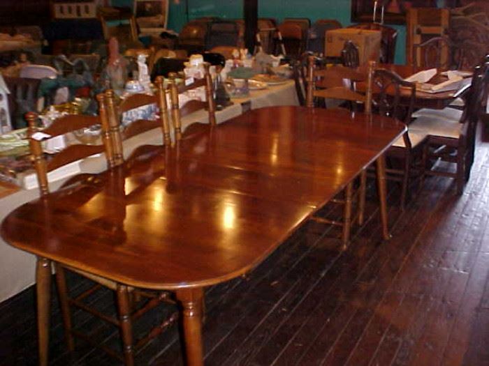 Thomasville solid cherry dining table w/4 leaves.  Set of 4 ladder back chairs,.
