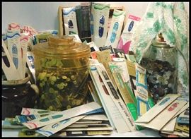 More than one hundred new old stock zippers and many buttons plus a button lamp