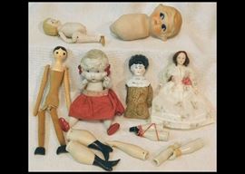 Porcelain dolls, wooden doll and doll parts.