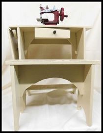 Child's toy sewing machine mounted on painted wooden base with bench