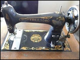 The Free no 5 treadle machine on a cabinet