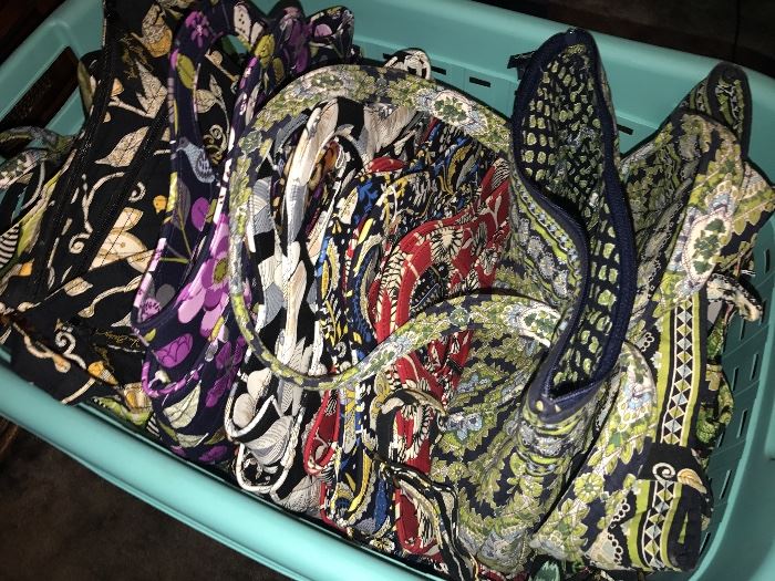 A basket full of Vera Bradley in a variety of sizes and patterns