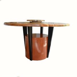 Vintage Hand-Crafted Mid Century Modern Dining Table: A vintage hand-crafted Mid Century Modern dining table. This round table is made of a composite of cherry, maple, and padauk wood forming a striped pattern on the table surface. A cylindrical cherry base supports four black tapered legs. A Lazy Susan and a stamp holder of similar design are also included.