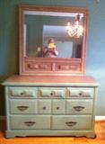 dresser that has been painted on teal green