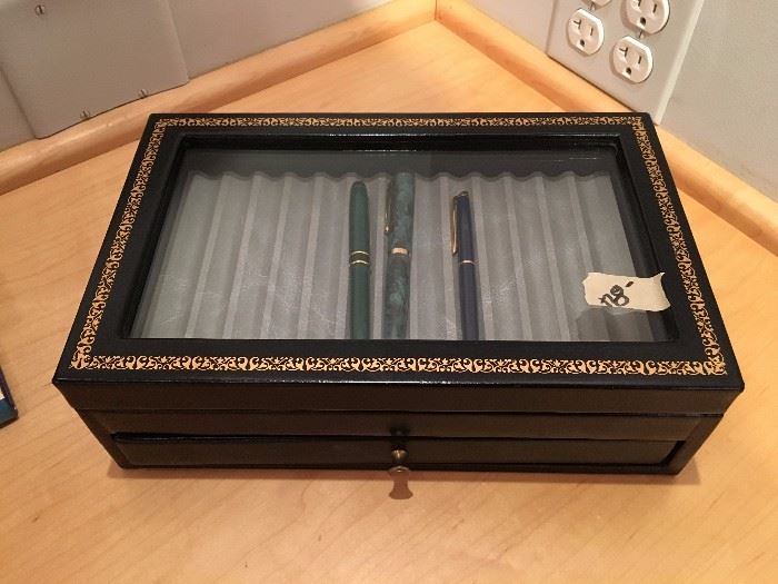 Collectible pens and storage box.