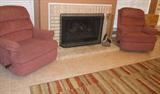 Two rocker recliner chairs. Large area rug