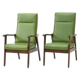 Mid Century Modern Oak Arm Chairs: A pair of Mid Century Modern oak arm chairs with green vinyl upholstery. These chairs feature a medium to a dark-stained oak frame with curved arms, straight seat rails, and splayed legs. Each is covered with padded green vinyl upholstery.