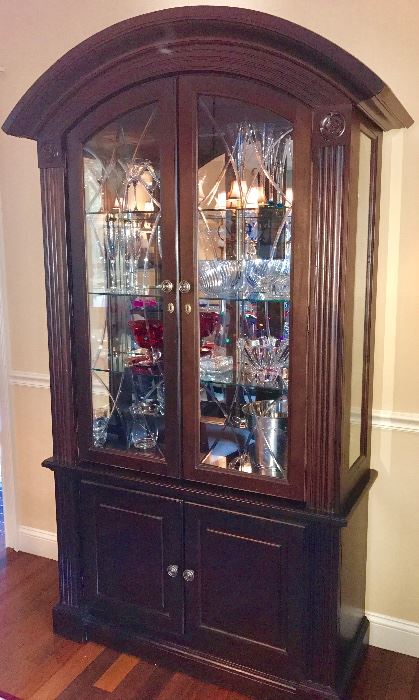 China cabinet full of beautiful crystal pieces
