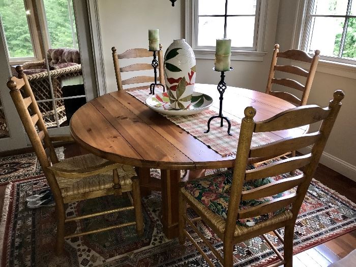 Pine kitchen table with extensions. Chairs feature rush seats.