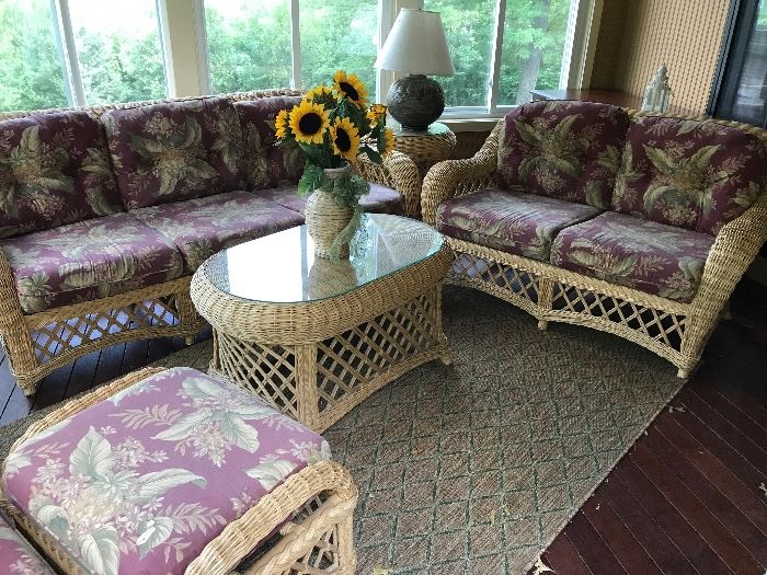 Features a sofa, love seat and single chair with ottoman. Table in the middle with glass top. Rug below for sale as well to complete the room!