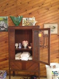 china  cabinet with vintage table cloths, Hull, McCoy, Shawnee