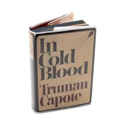 First Edition Truman Capote "In Cold Blood": A first edition, first printing hardcover copy of Truman Capote’s classic true crime book In Cold Blood. Published January 1966 (stated copyright date of 1965) by Random House. It retains its original dust jacket designed by S. Neil Fujita, with an outer plastic sleeve.