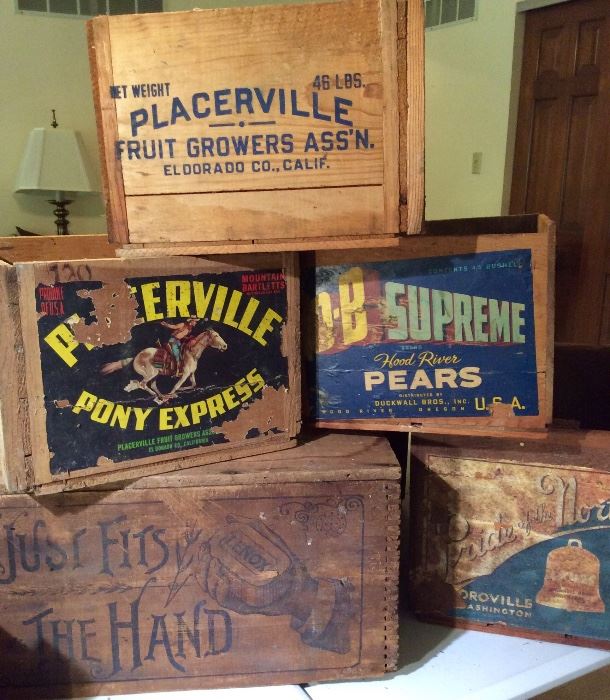 Several vintage wooden crates with advertising.