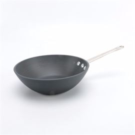 Calphalon Cast Iron Skillet: A Calphalon cast iron skillet. This cast iron skillet features a rounded wok style bowl with a straight handle with cut out for hanging. Skillet is marked to the underside.