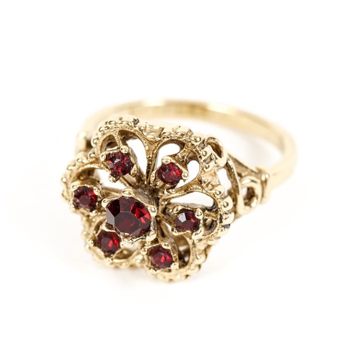 18K Gold and Garnet Ring: An ornate gold ring with pyrope garnets. The ring has a hexagonal head with seven prong-set garnets.
