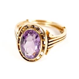 Amethyst Ring in 18K Yellow Gold: An 18K yellow gold ring featuring a pierced bezel setting with an amethyst gemstone.