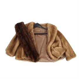 Mink Fur Coat and Stole: A vintage mink fur coat and stole. The coat is made of a light warm brown colored mink fur, featuring a shawl collar and three-quarter length sleeves. It is lined in tan silk or satin-like fabric and is not labeled. The stole is made of dark brown mink and is lined in dark brown velveteen. No maker’s marks.