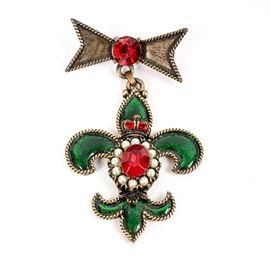 Vintage Weiss Rhinestone Fleur–de–Lis Brooch: A vintage gold tone and enamel fleur-de-lis brooch with faux pearls and rhinestones. The brooch has a ribbon motif at the top, with a fleur-de-lis dangle, featuring green enamel and red rhinestones with faux seed pearls. It is marked “Weiss”.