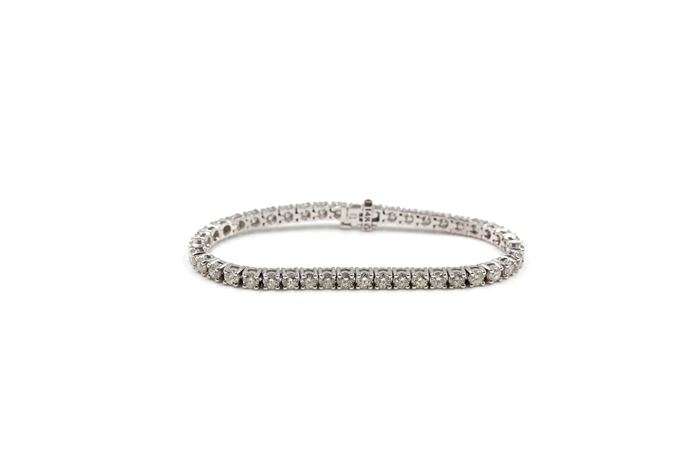 14K White Gold 8.00 CTW Diamond Bracelet: A white gold line bracelet of basket prong set full cut diamonds. The bracelet is in excellent condition and has never been worn.