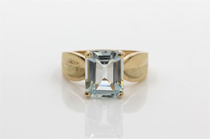 14K Yellow Gold 2.30 CTS Aquamarine Ring: A large emerald cut aquamarine is basket prong set to the center of a wide tapered yellow gold shank.