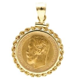 22K Yellow Gold 1898 Russian Sovereign Coin Pendant: A 22K yellow gold 1898 Russian sovereign coin issued by the Russian Empire during the reign of Tsar Nicholas II of which the mintage totaled 52,378,000. This coin depicts a left facing bust of Nicholas II, the last Tsar of the Russian Empire to the obverse and the Russian imperial eagle along with the denomination and date to the reverse. The coin represents five rubles, is ninety percent gold and housed in a 14K yellow gold pendant bezel.