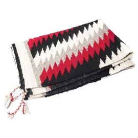 Verkamp's Mid Century Navajo Wool Rug: A mid century Navajo wool blanket from Verkamp’s. Handwoven in traditional native motif of sharp geometric shapes in red, black gray and white with unresolved borders in white, black and gray. This rug bares original tag and has loops for hanging.