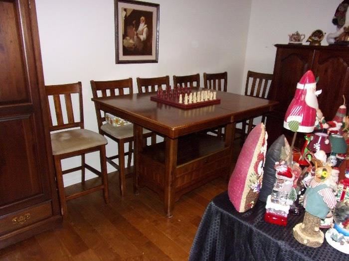 Pub height table and 6 chairs with built in leaves and storage below. Selling table and chairs seperately.