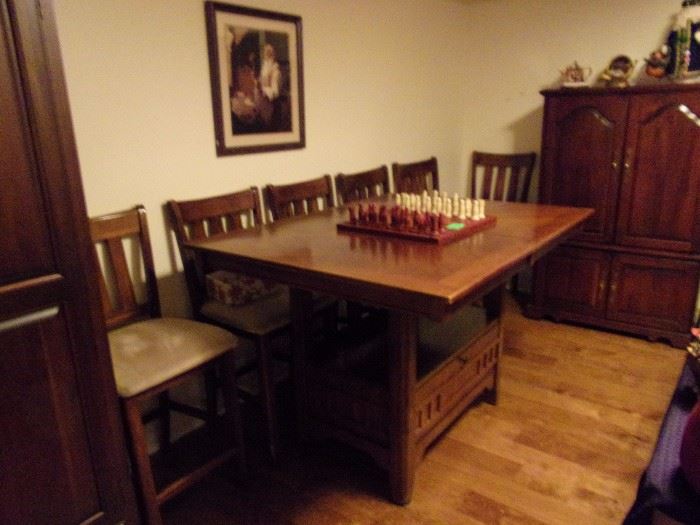 Pub height table and 6 chairs with built in leaves and storage below. Selling table and chairs seperately.