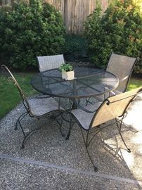 Woodard wrought iron table and four matching chairs