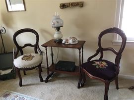 needle point chairs and table with milk glass lamp