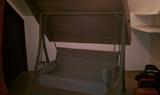Covered bench swing