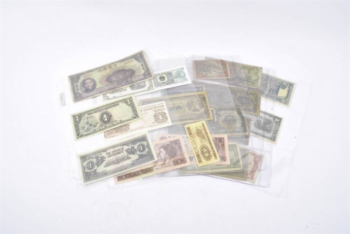 Collection of U.S. and Foreign Currency: A collection of U.S. and foreign currency. This grouping features 22 notes in total. Highlights of the assortment include banknotes from the Japanese government, Philippines, Iran, Nicaragua, Laos, Japan, U.S. Department of Agriculture and more.