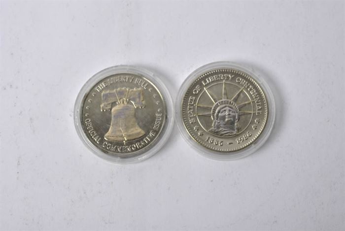 Pair of U.S. Commemorative Coins: A pair of U.S. commemorative coins. This selection features a pair of commemorative Liberty Bell and Statue of Liberty coins. Each coin is encapsulated in a plastic protective case.
