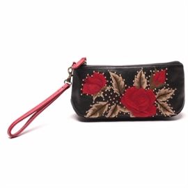Isabella Fiore Wristlet With Leather Rose Embroidery: An Isabella Fiore wristlet with leather rose embroidery. This bag features a black leather exterior with embroidered roses, brown, stems, and green leaves accented with gold tone rivets. Other details include a zip top closure with a red leather pull, and a removable red leather wrist strap on a swivel spring hook. The interior is lined red bandana print fabric with a side wall slip pocket labeled “Isabella Fiore”.
