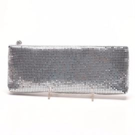 Neiman Marcus Silver Tone Mesh Clutch: A Neiman Marcus silver tone mesh clutch. This clutch features a silver tone mesh exterior, a zip top closure with a rhinestone enhanced pendant style zipper pull, and a white satin lining with a sidewall slip pocket. The interior is labeled “Neiman Marcus” and the bag comes with a branded Neiman Marcus" box.