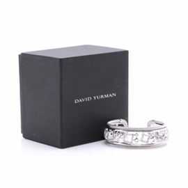 David Yurman Quatrefoil Sterling Silver and Diamond Cuff: A David Yurman quatrefoil sterling silver and 0.82 ctw diamond cuff bracelet. This cuff bracelet features an openwork ornamental quatrefoil design in graduating sizes, which are either diamond encrusted or have a bright polished finish. A twisted sterling wire and plain wire pattern border the edges of the cuff.