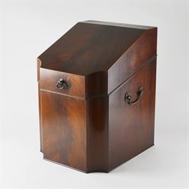 Vintage Walnut Veneer Vinyl Record Storage Box: A vintage walnut veneer vinyl record storage box. Designed with a slanted lid and angular design, this walnut veneer box can hold 45 size records. It includes a front pull, sliding rear hinges, with side handles, and interior grooves. The box is stamped with an illegible mark.