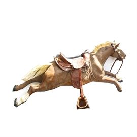 Vintage Bally "Champion" Coin Operated Horse Ride: A Champion coin operated mechanical horse by Bally. The mechanical works in the base appear to be intact. The horse is tan with a white mane and tail and two white hooves on opposing front and back legs. The saddle is tooled leather with silver tone hardware. The base has been painted a solid green color. Manufacturer's tag is present but painted over.