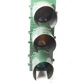 Vintage Econolite Traffic Light: A vintage metal Econolight traffic light. This piece features a green painted metal body with three lights.