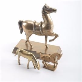 Collection of Brass Horses: A collection of three brass horses. Two are standing on bases while one is free standing bending like it is grazing. All are unmarked.