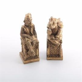 Southeast Asian Style Figurines: A pair of southeast Asian style figurines. This features a monkey and an elephant each sitting on a carved stone like base. They are made of plastic and finished in a bronze tone.