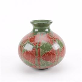 Fish Pottery Vase: A fish pottery vase. The vase has a mirrored fish design alternating red and green. Marked, “Bladimir N Nicaragua.”