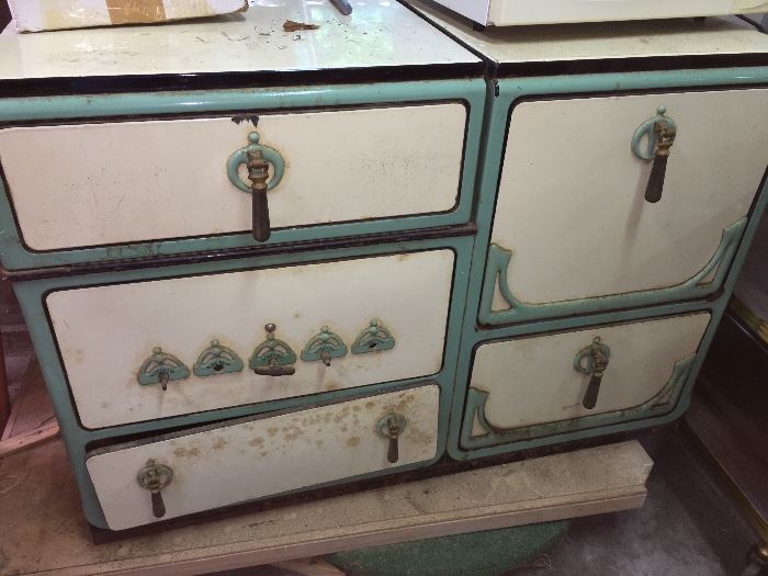 Antique porcelain stove in teal and white.