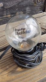 vintage socket and aerolux lightbulb with happy birthday filament 