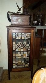 stunning music cabinet loaded with piano rolls topped off with a victor phonoraph