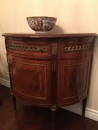 marquetry demilune cabinet embellished with brass.       