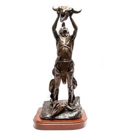 Sid Burns 1972 Bronze Sculpture "We Beseech Thee": A 1972 bronze sculpture titled We Beseech Thee by Sid Burns (1916 – 1979). Burns, who was born in Oklahoma and resided in Arizona for much of his life, was a self-taught artist who began sculpting at the age of 50. Best known for his Western-related subjects, this work is indicative of Burn’s expressive style and meticulous attention towards detail. The sculpture depicts an American Indian holding a buffalo skull up to the sky while another skull lays at his feet below. The piece is numbered 12 of 24, dated, 1972, titled We Beseech Thee and signed by Sid Burns to its base. The work is presented on a wooden base.
