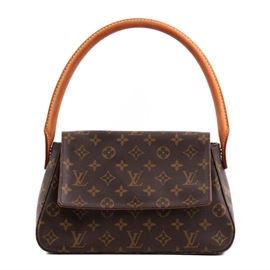 Louis Vuitton Mini Looping Monogram Handbag: A Louis Vuitton Mini Looping monogram canvas handbag. This designer bag features the classic monogram coated canvas monogram with a single leather top handle. Bag has a flap top with a magnetic snap closure. It is lined in brown canvas with a single interior zip pocket. Leather label to interior reads “Louis Vuitton Paris Made in U.S.A.”. The date code, located on a fabric tag to interior of zippered pocket, is “SD0081”.