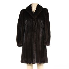 Mahogany Mink Fur Full-Length Coat: A mahogany mink fur full-length coat. This piece of outerwear features plush female mink pelts to exterior with velvet lined pockets and hook and eye closure. Coat is lined in black satin and features an interior pocket. Interior label reads “Furrari New York”.