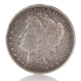 1880-CC Morgan Silver Dollar: An 1880-CC Morgan silver dollar. This antique coin was minted at Carson City with a mintage of 495,000. It was designed by George T Morgan. This coin has a metal composition of 90% silver and 10% copper, a diameter of 38.1 mm, a weight of 26.73 grams.